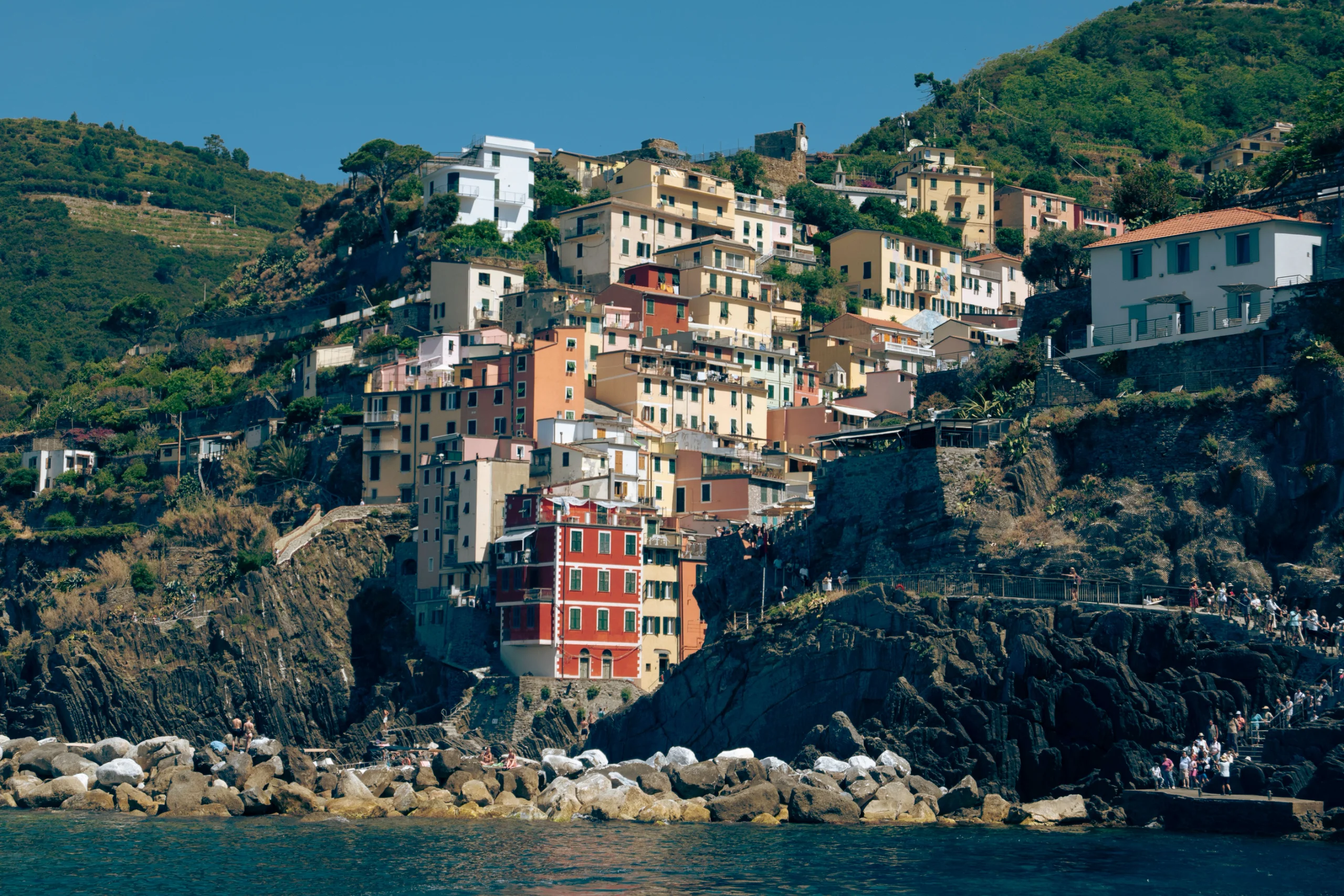 Colorful hillside view of the coastal village in Liguria, Italy, with vibrant buildings and rugged c jigsaw puzzle