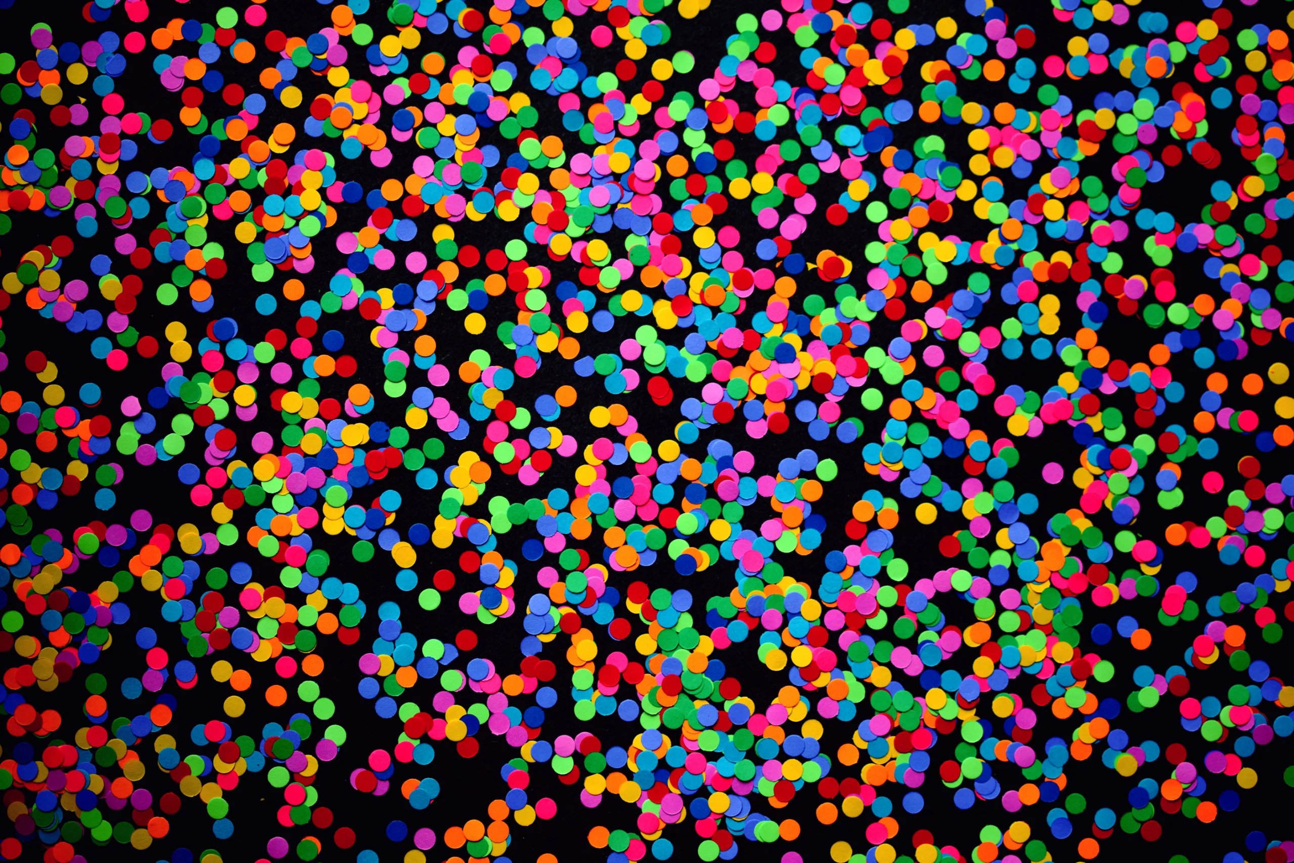 A vibrant, colorful confetti spread against a dark backdrop, perfect for celebrations. jigsaw puzzle