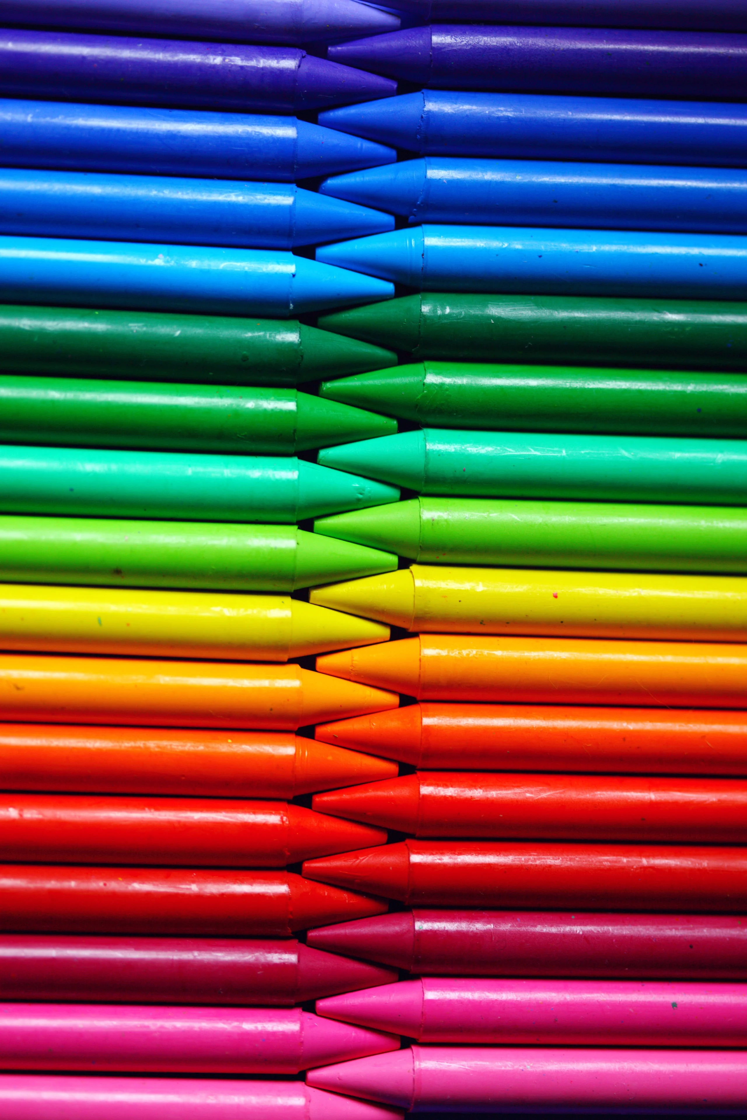 Colorful arrangement of crayons showcasing the spectrum of colors in a close-up vertical shot. jigsaw puzzle