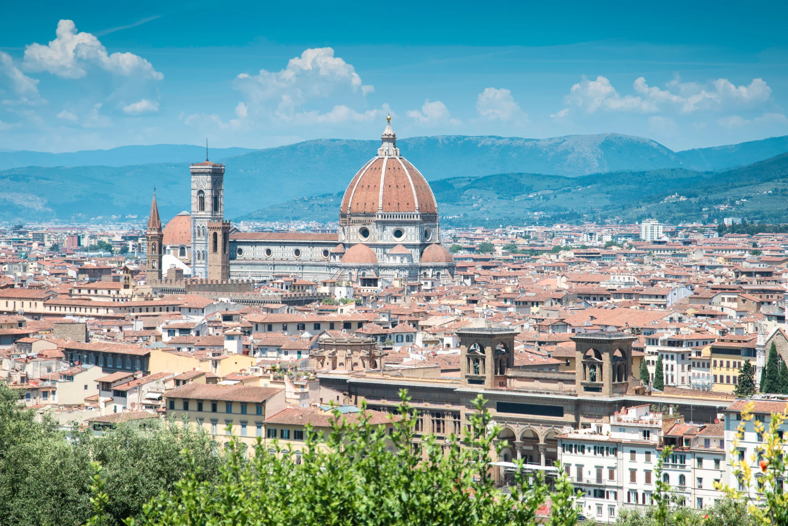 A stunning view of Florence featuring the iconic Santa Maria del Fiore under a bright blue sky. jigsaw puzzle
